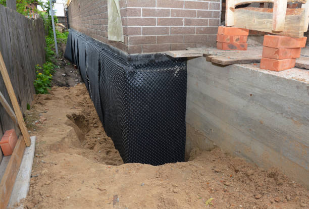 SJ Waterproofing Pros technician performing targeted Interior Drainage System assessment in Merrill, MI